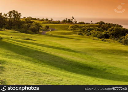 Beautiful View of Green Golf Field with Blue Sky.