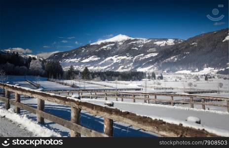 Beautiful view of highland farm covered by snow in Austrian Alps