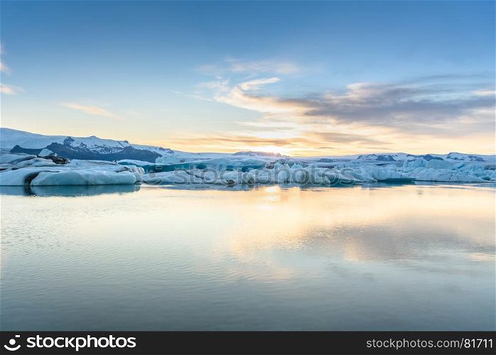 Beautiful view of icebergs in Jokulsarlon glacier lagoon at sunset, Iceland, global warming concept, selective focus