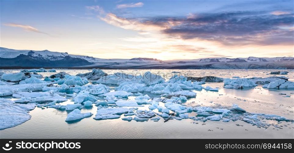 Beautiful view of icebergs in Jokulsarlon glacier lagoon at sunset, Iceland, global warming concept