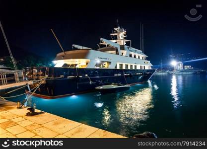 Beautiful view of luxurious private yacht moored at night port