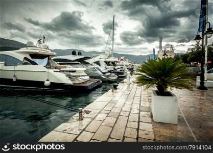 Beautiful view of moored luxurious yachts at cloudy and rainy day