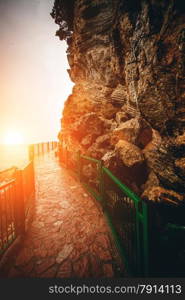 Beautiful view of path with handrails in high mountains at sunset