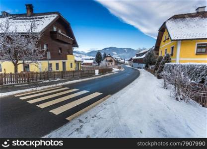 Beautiful view of road going through small town in Austrian Alps