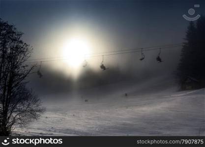 Beautiful view of ski lifts on high mountain covered by snow