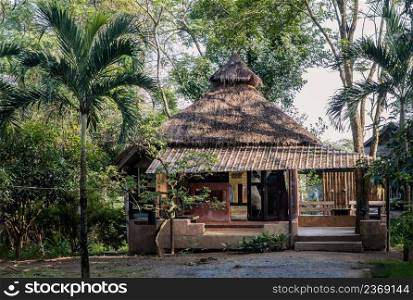 Beautiful view of Summer wooden cottage or Summer wooden bungalow surrounded by a beautiful tropical park. Selective focus.