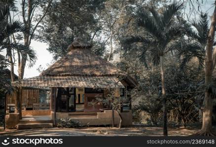 Beautiful view of Summer wooden cottage or Summer wooden bungalow surrounded by a beautiful tropical park. Selective focus.
