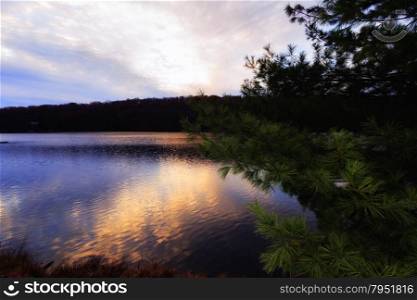 Beautiful view of sunset on the forest lake.. View of the sunset on the forest lake.