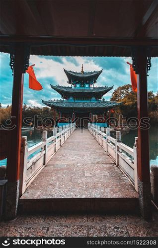 Beautiful view of the Jade Dragon Snow Mountain and the Suocui Bridge over the Black Dragon Pool in the Jade Spring Park, Lijiang, Yunnan