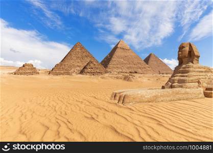 Beautiful view of the Pyramids and the Sphinx in Giza desert, Egypt.. Beautiful view of the Pyramids and the Sphinx in Giza desert, Egypt