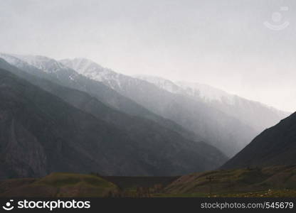 Beautiful view of the silhouettes of the Altai mountain ranges in rainy weather and fog.. Beautiful view of the silhouettes of the Altai mountain ranges in rainy weather and fog