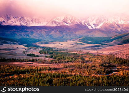 Beautiful view of the snowy mountain peaks. Colorful mountain valley with rocks.