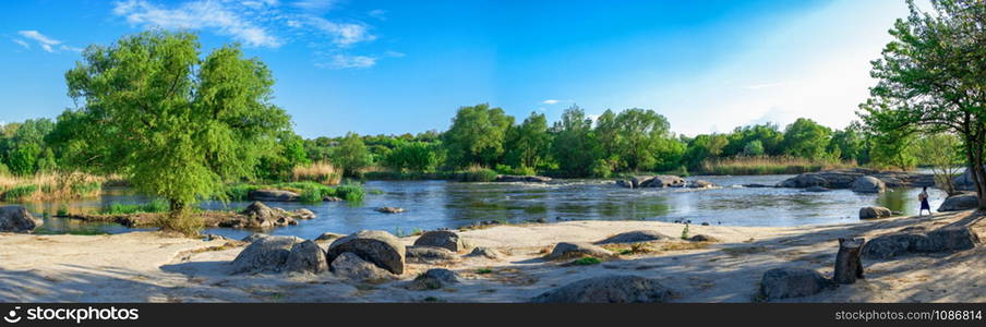 Beautiful view of the Southern Bug River near the village of Migiya on a sunny spring day. Spill of the Southern Bug River in the village of Migiya, Ukraine