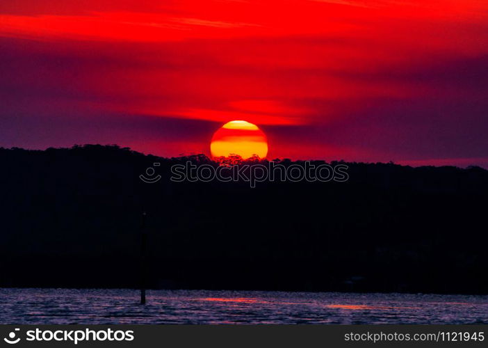 Beautiful view of the sunset in the colorful sky over the calm ocean