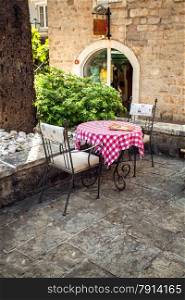 Beautiful view of two chairs and table on summer terrace of old restaurant