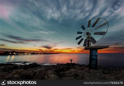 Beautiful View on a Great Windmill over Sunset Sky Background on the Sea Coast. Anfeh. Lebanon