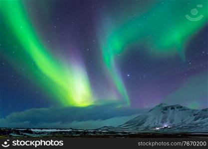 Beautiful view on Aurora Borealis, the amazing northern light in the night sky, wonderful nature of Iceland