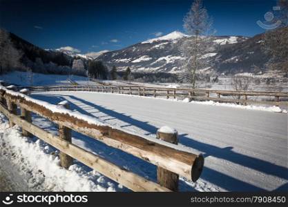 Beautiful view on mountain road covered by snow in Austrian Alps at sunny day