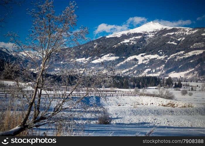 Beautiful view on valley at high Austrian mountains covered by snow