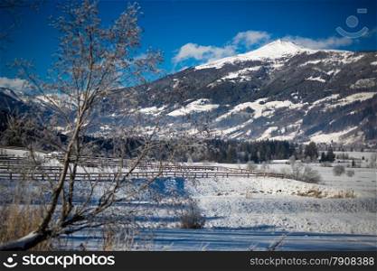 Beautiful view on valley at high Austrian mountains covered by snow