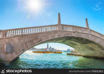 Beautiful view to white bridge over canal and exit to bay. Venice, Italy