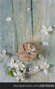Beautiful vintage background from old blue boards, white spring flowers and gift box, with copy-space