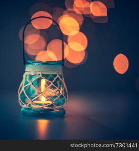 Beautiful vintage candlestick on blurry lights background, antique decor in restaurant interior, romantic candlelight atmosphere  