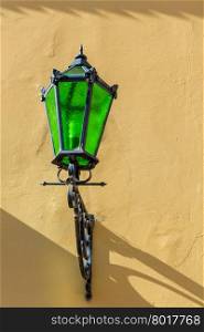 beautiful vintage lamp on a yellow wall of building
