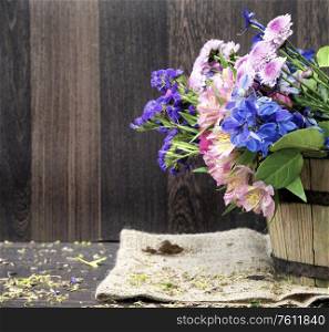 Beautiful vintage look applied to romantic flower and garden paraphenalia still life image with Spring and Summer seasonal blooms