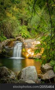 Beautiful water stream in Poco da Cilha waterfall, Manhouce, Sao Pedro do Sul, Portugal. Long exposure smooth effect. Mountain forest landscape.