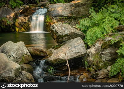 Beautiful water stream in Poco da Cilha waterfall, Manhouce, Sao Pedro do Sul, Portugal. Long exposure smooth effect. Mountain forest landscape.