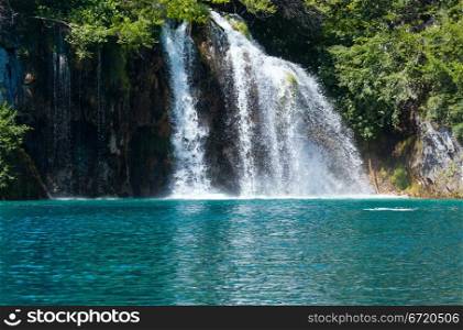 Beautiful waterfall and sea-green limpid lake in Plitvice Lakes National Park (Croatia)