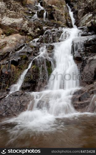 Beautiful waterfall falling on a stone wall
