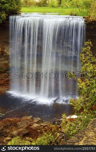 Beautiful waterfall flowing over natural rock formation