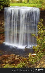 Beautiful waterfall flowing over natural rock formation