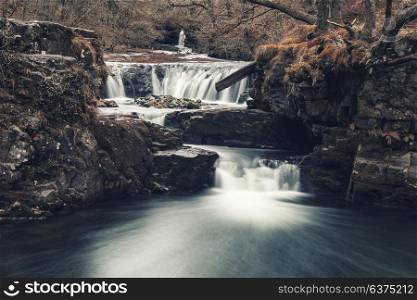 Beautiful waterfall landscape image in forest during Autumn Fall