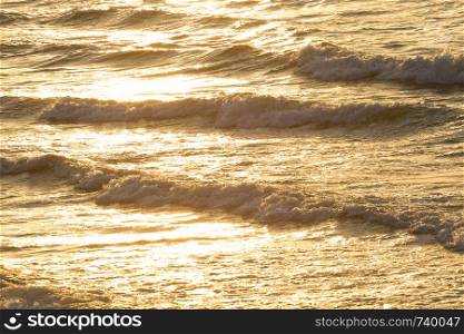 Beautiful waves of the sea at the sunrise