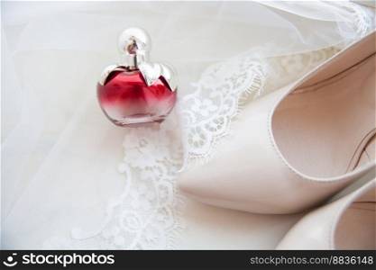 beautiful wedding accessories. Bride shoes, perfumes on a white veil.. beautiful wedding accessories. Bride shoes, perfumes on a white veil