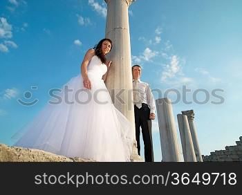 Beautiful wedding couple- bride and groom near greece column in the ancient city