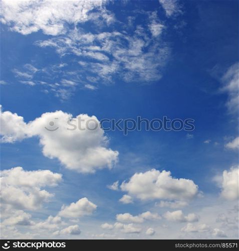 Beautiful white clouds in the dark blue sky. Heavenly background.