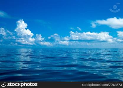Beautiful white clouds on blue sky over calm sea