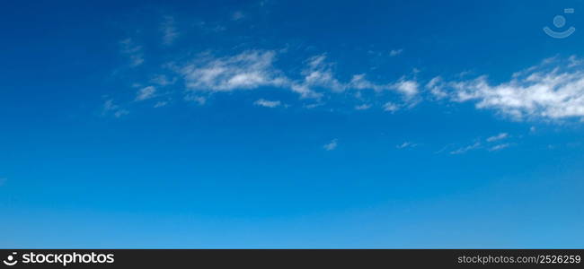 Beautiful white clouds on clear blue sky. Panorama