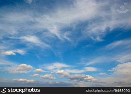 Beautiful white fluffy clouds against bright blue sky.
