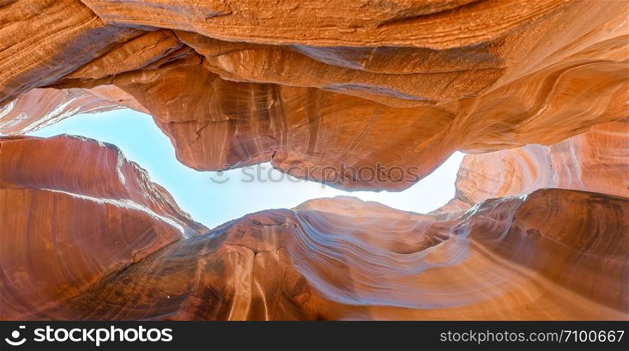 Beautiful wide angle view of amazing sandstone formations in famous Antelope Canyon, bottom-up skyward view.