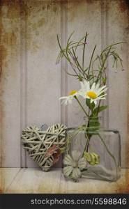 Beautiful wild flower in vase with heart still life love concept