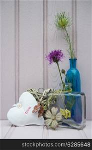 Beautiful wild flower in vase with heart still life love concept