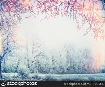 Beautiful winter country landscape with snow trees and frame of branches