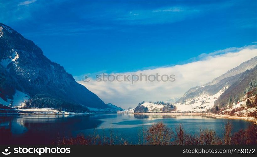 Beautiful winter lake and snowy mountains. Winter landscape