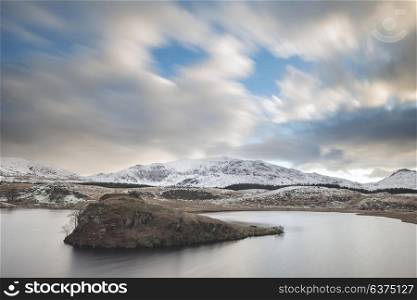 Beautiful Winter landscape image of Llyn y Dywarchen in Snowdonia National Park