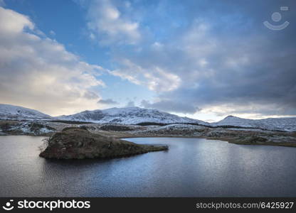 Beautiful Winter landscape image of Llyn y Dywarchen in Snowdonia National Park